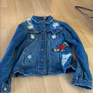 Distressed denim jacket with appliqué
